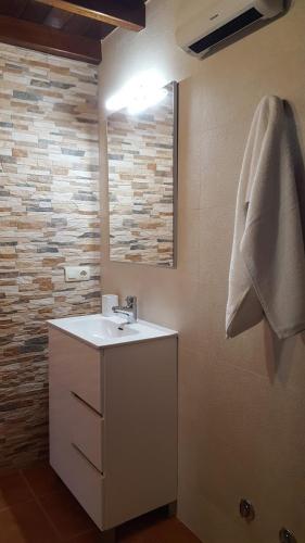 a bathroom with a sink and a mirror at Casa Madrilejo in Outes