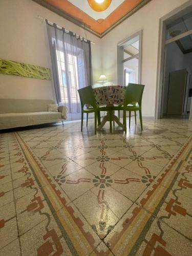 a living room with a table and chairs on a rug at La Mattanza in Trapani
