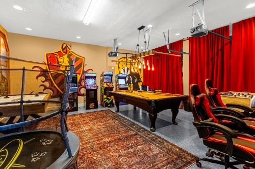 a game room with ping pong tables and consoles at Elegant Disney Vacation Home on Reunion Resort in Kissimmee
