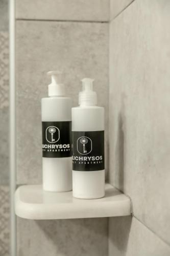 two bottles ofodorizers sitting on a shelf in a bathroom at Elichrysos Cozy Apartment in Heraklion