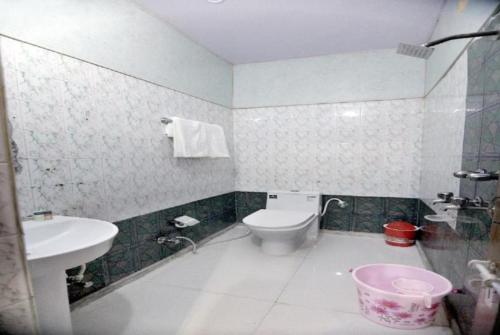 a bathroom with a toilet and a sink at Hotel Reshmi In Agra Near Chandrashekhar Park - Best Location in Agra