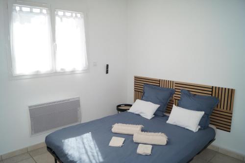 - une chambre avec un lit bleu et 2 serviettes dans l'établissement Chambre d'hôte dans une propriété avec piscine, 