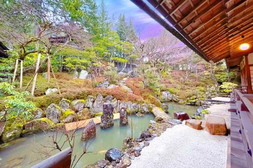 a view of a garden with rocks and a river at Koyasan Sanadabo Rengejoin in Koyasan