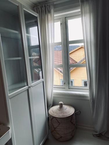 a room with two windows and a basket in front thereof at Bed and Brunsj, Sand in Sand