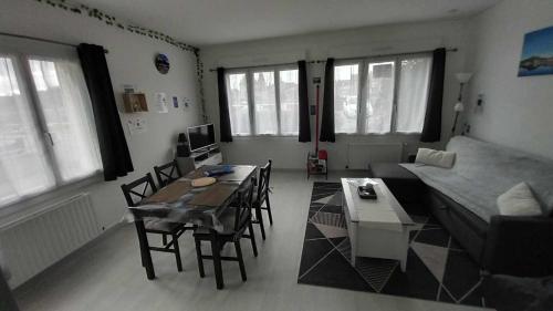 a living room with a couch and a table at Le Bellevue in Givet