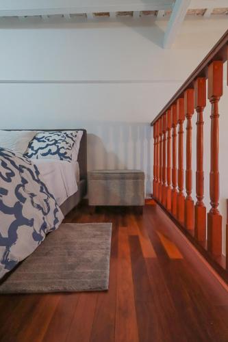 a bedroom with a bed and a wooden floor at Old San Juan Historic Loft 4 The Adventurous in San Juan