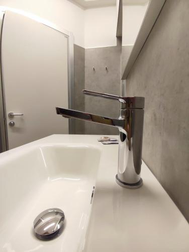 a bathroom sink with a chrome faucet on it at Residence Al Granzo in Trieste