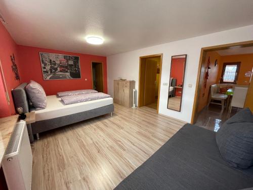 a bedroom with a bed in a room with red walls at Gästehaus Durst in Rust