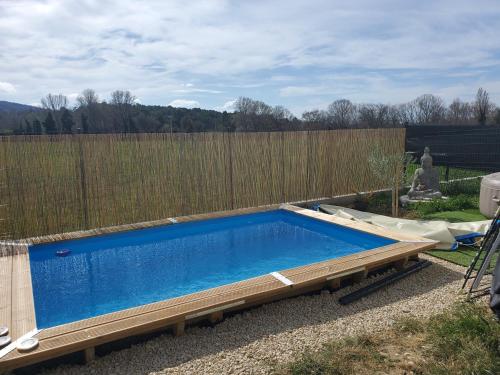 - une piscine dans une cour à côté d'une clôture dans l'établissement Les Alizés, à La Bâtie-Rolland