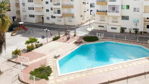 an overhead view of a swimming pool in a building at 2 bdr apt in Palmarejo Baixo, near seafront - LCGR in Praia
