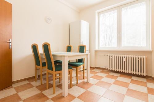 a dining room with a table and four chairs at Apartment Anna in Bratislava