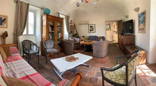 a living room with a couch and a table at Mas Escombelle in Barjac