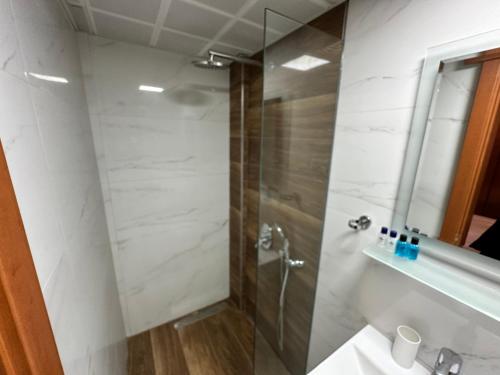 a bathroom with a shower and a sink at Hotel Karyatit Kaleici in Antalya