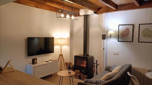 a living room with a couch and a fire place at Zarraci La Guía in Gijón