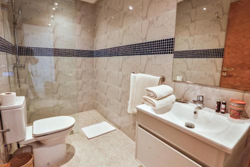 a bathroom with a sink and a toilet and a shower at Hanah Apartments by Living Essaouira in Essaouira