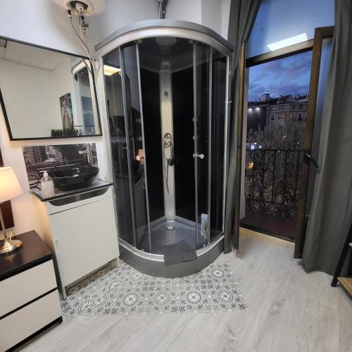 a bathroom with a shower with a view of a city at ROOMS OPERA in Madrid