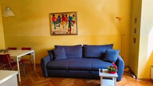 a living room with a blue couch and a table at Apartment Colors of Life in Rijeka