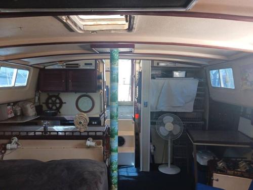 an inside view of an rv with a table and a fan at Dream Lady in Jewfish