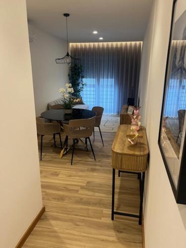 a living room with a table and a dining room at My Home in Braga