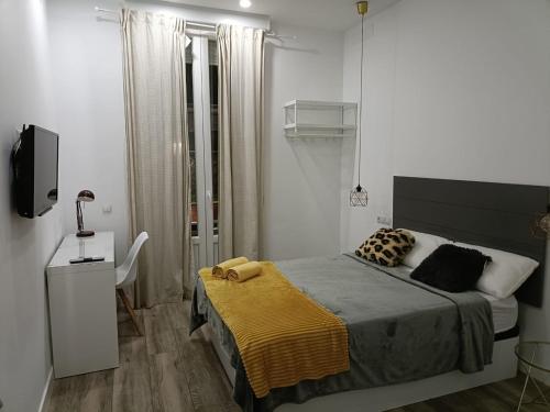 מיטה או מיטות בחדר ב-Habitaciones Centro de Madrid
