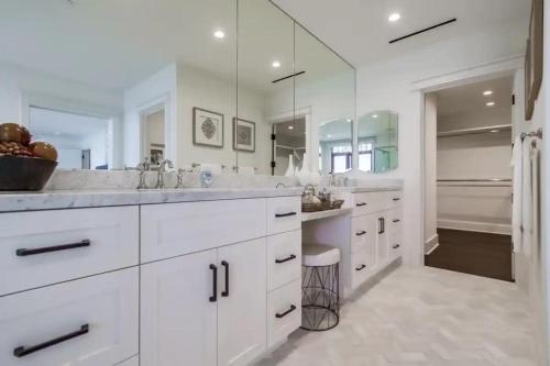 a white bathroom with two sinks and a large mirror at La Jolla Cove-Oceanfront 5600SF 3BR+Loft 5BA House best Villiage location walk everywhere in San Diego