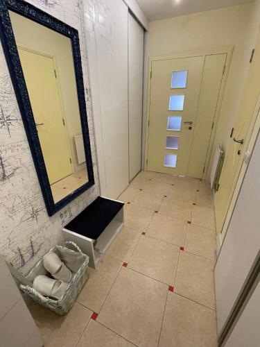 a bathroom with a mirror on the wall at Apartment Next Door in Novi Sad