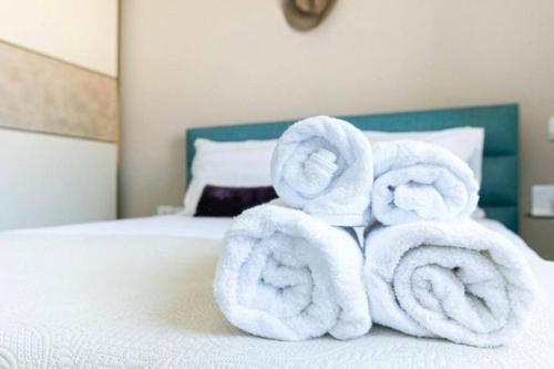 two towels are stacked on top of a bed at Luxury Suite 3 in Himara in Himare