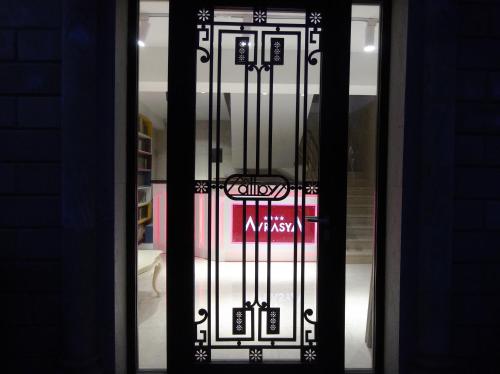 a glass door of a store with a sign on it at Avrasya Hotel in Baku