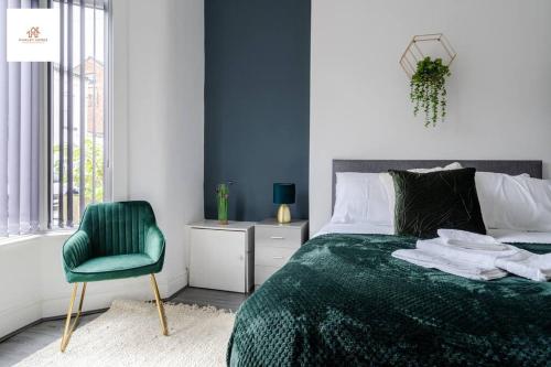 um quarto com uma cama verde e uma cadeira verde em Large 3 bedroom sleeps-7/Gartson/Liverpool em Liverpool