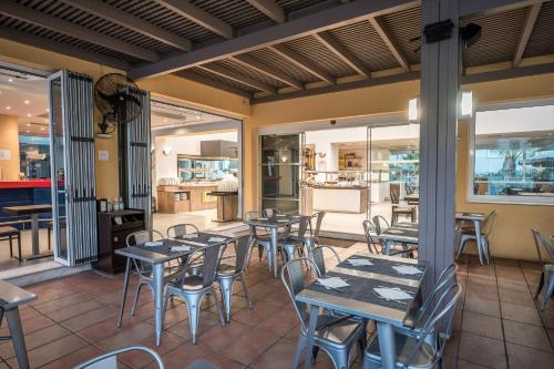 a restaurant with tables and chairs on a patio at Meropi Hotel & Apartments in Malia