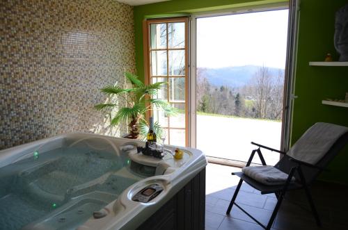 a bathroom with a tub with a plant in it at Holiday Home with Hot tub and Sauna Sabina in Rovte