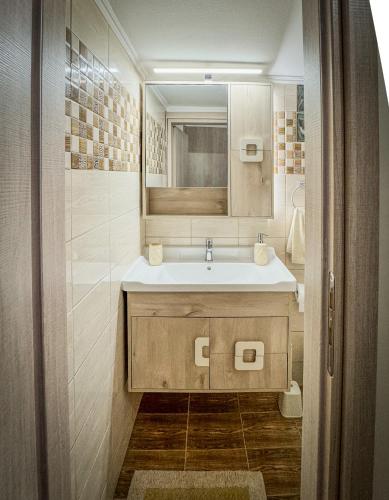 a bathroom with a sink and a mirror at Alyki Salamina House in Salamina