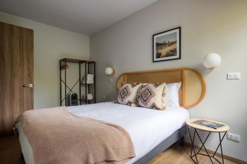 a bedroom with a large white bed with pillows at VICENTE SUAREZ By Mr W in Mexico City