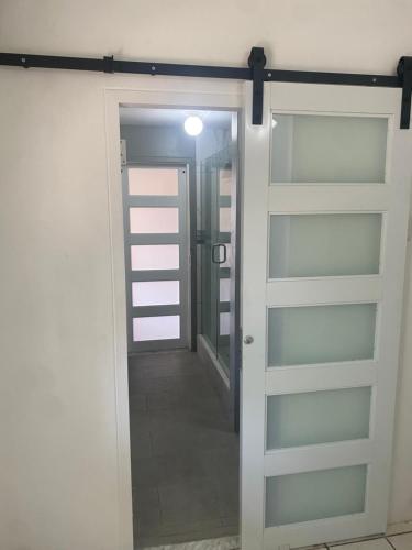 a door leading into a room with a hallway at HCEAS villa is 5 min fr. airport & to the beaches in Bon Accord