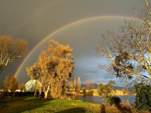 a rainbow in the sky over a body of water at Art Hotel Pietrasanta in Pietrasanta
