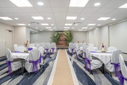a conference room with white tables and chairs at Comfort Inn & Suites New Orleans Airport North in Kenner