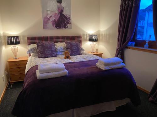 a bedroom with a bed with a dog sitting on it at Cameron apartment Loch Ness in Fort Augustus