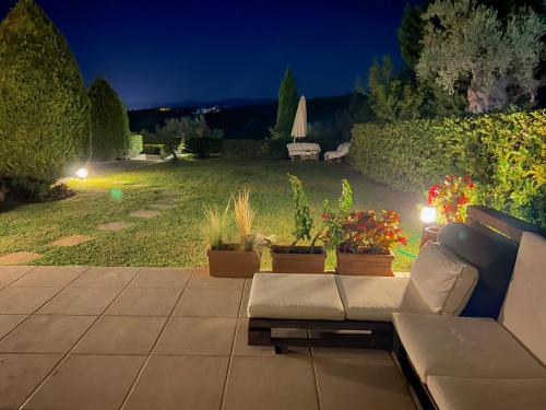 a patio with a couch and potted plants at night at Angelo’s Elegant Summer House in Possidi
