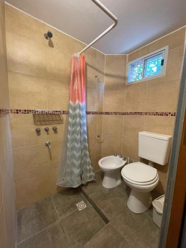 a bathroom with a toilet and a shower at Tila Huasi in Villa Icho Cruz
