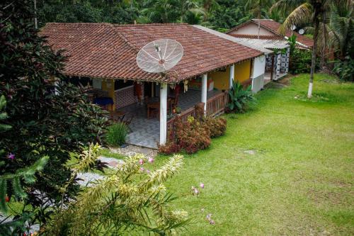 a house with a large yard in front of it at Pousada cachoeira de Paraty in Sertão do Taquari