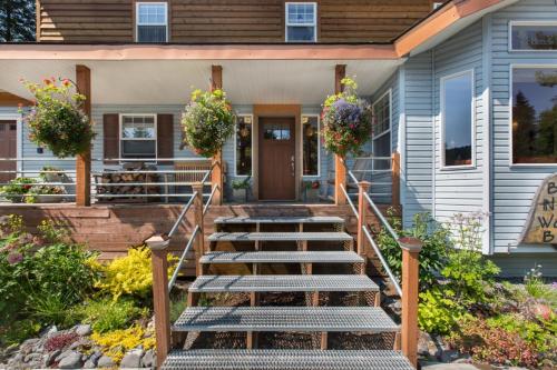 a house with stairs leading to the front door at Bell In The Woods B&B in Seward