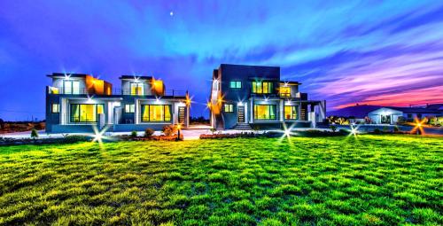 a large house with a green lawn in front of it at Boreum Pension in Seogwipo
