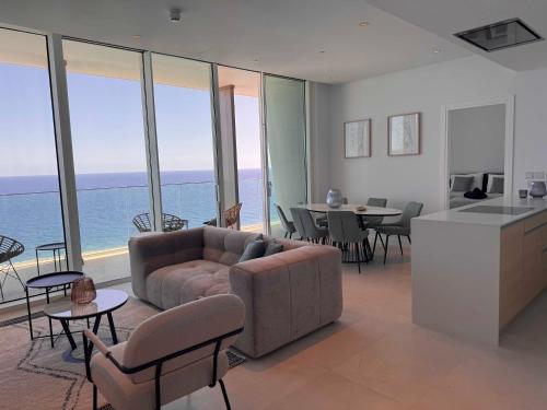 a living room with a couch and a table at Ayia Napa Marina Exclusive Apartment in Ayia Napa