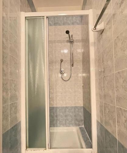 a shower with a glass door in a bathroom at Sea view apartment in Caorle in Caorle