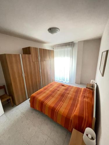 a bedroom with a large bed and a window at Sea view apartment in Caorle in Caorle