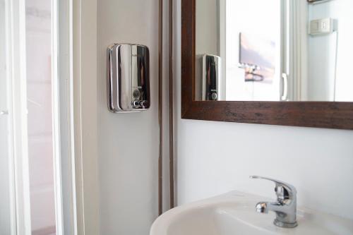 a bathroom with a sink and a mirror at Lago Maggiore Lesa Elena home in Lesa