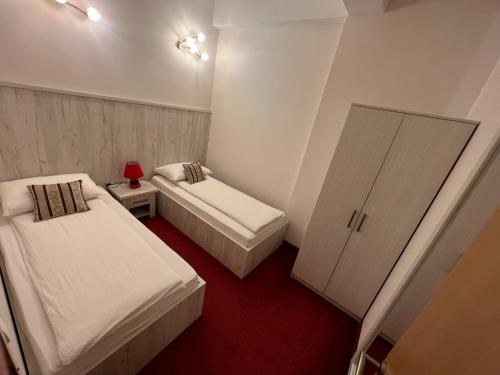 a small room with two beds and a cabinet at Apartmani Villa Grande in Bugojno