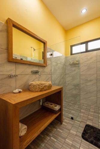 a bathroom with a shower and a sink and a mirror at Condominios Brisas del Mar in Santa Cruz Huatulco