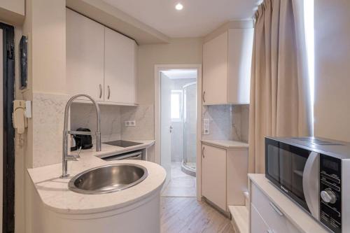 a small kitchen with a sink and a sink at Penthouse in the heart of Athens in Athens