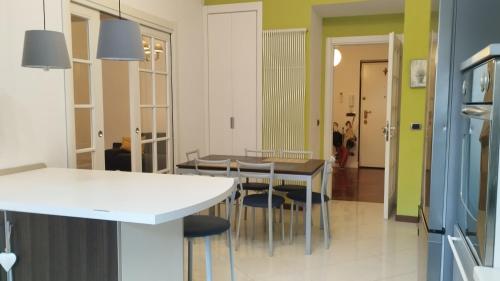 a kitchen and dining room with a table and chairs at House Rossini in Turin